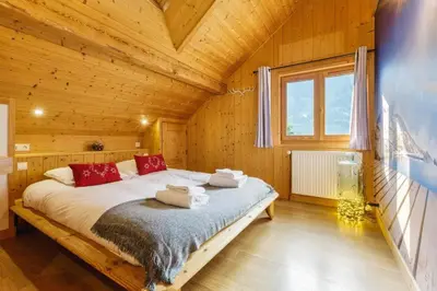 a bedroom with a bed in a wooden cabin at MontBlanc Balcony Chamonix in Chamonix-Mont-Blanc