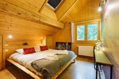 a bedroom with a bed in a wooden room at MontBlanc Balcony Chamonix in Chamonix-Mont-Blanc