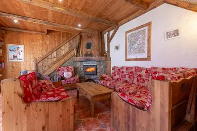 a living room with couches and a fireplace at Chalet Quatre Saisons in Saint-Gervais-les-Bains