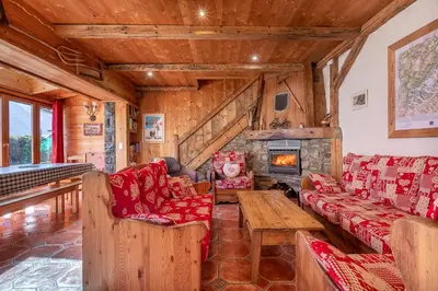 a living room with couches and a fireplace at Chalet Quatre Saisons in Saint-Gervais-les-Bains