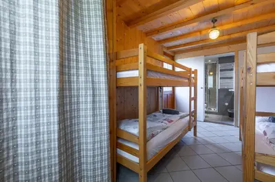a bedroom with two bunk beds in a cabin at Chalet Quatre Saisons in Saint-Gervais-les-Bains