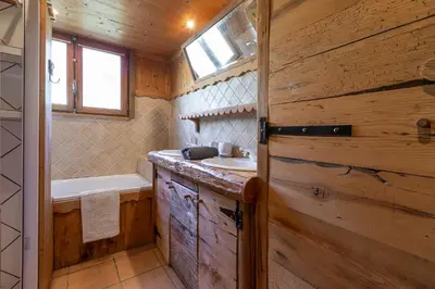 a bathroom with a tub and a sink and a bath tub at Chalet Quatre Saisons in Saint-Gervais-les-Bains