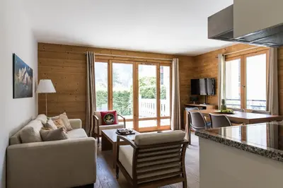 a living room with a couch and a table at Villa Floria Apartment in Chamonix-Mont-Blanc
