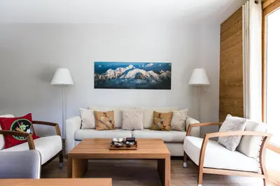 a living room with a couch and a table at Villa Floria Apartment in Chamonix-Mont-Blanc