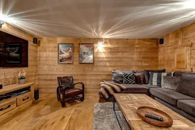 a living room with a couch and a table at Chalet Planards 2 in Chamonix-Mont-Blanc