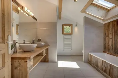 a bathroom with two sinks and a tub at Chalet Planards 2 in Chamonix-Mont-Blanc