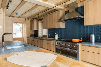 a kitchen with wooden cabinets and a stove top oven at Chalet Le Favre in Chamonix-Mont-Blanc