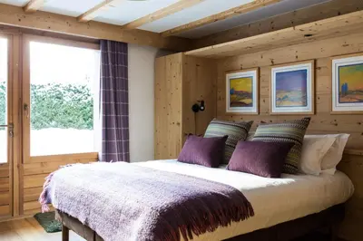 a bedroom with a large bed in a room at Chalet Le Favre in Chamonix-Mont-Blanc