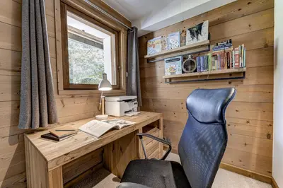 an office in a tiny house with a desk and a chair at Chalet les Sauberands in Chamonix-Mont-Blanc