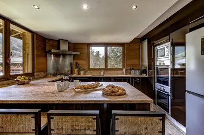 a kitchen with a large island with bread on it at Chalet les Sauberands in Chamonix-Mont-Blanc
