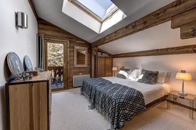 a bedroom with a bed and a skylight at Chalet les Sauberands in Chamonix-Mont-Blanc