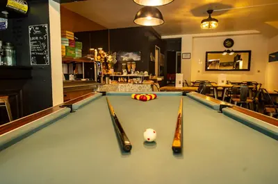 a pool table with three cue balls on it at Hotel La Chaumière à 180m du télécabine et de la gare in Saint-Gervais-les-Bains