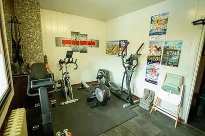 a gym with several exercise bikes in a room at Hotel La Chaumière à 180m du télécabine et de la gare in Saint-Gervais-les-Bains