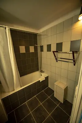 a bathroom with a tub and a toilet in it at Hotel La Chaumière à 180m du télécabine et de la gare in Saint-Gervais-les-Bains