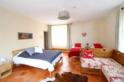 a bedroom with a bed and a couch in it at Le Moulin des Olirics in Sallanches
