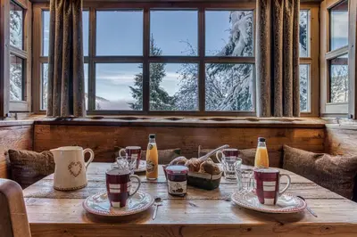 a wooden table with drinks and food on it at Chalet Persan in Megève