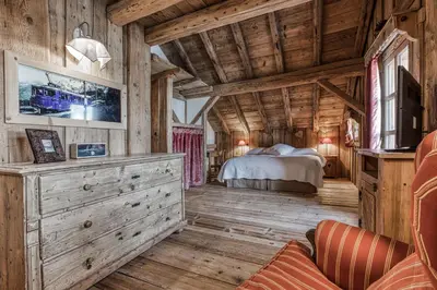 a bedroom in a log cabin with a bed at Chalet Persan in Megève