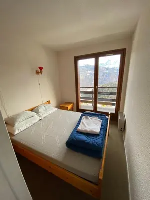 a bedroom with a bed with a large window at Amethyste in Saint-Gervais-les-Bains