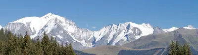 a snow covered mountain range with trees in the foreground at Amethyste in Saint-Gervais-les-Bains