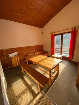 a room with a wooden table and a window at Amethyste in Saint-Gervais-les-Bains