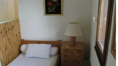 a bedroom with a bed with a lamp on a night stand at Amethyste in Saint-Gervais-les-Bains