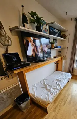 a room with a desk with a television and a bed at Cozy Chamonix Ski Studio with Mountain Views in Chamonix-Mont-Blanc