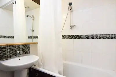 a bathroom with a sink and a toilet and a tub at Cozy Chamonix Ski Studio with Mountain Views in Chamonix-Mont-Blanc