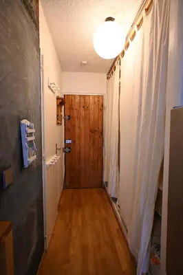 a hallway with a wooden door and a light at Cozy Chamonix Ski Studio with Mountain Views in Chamonix-Mont-Blanc