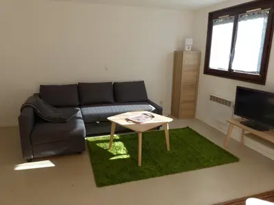 a living room with a couch and a table at Gîte Montvauthier in Les Houches