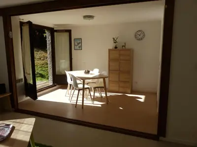 a table and chairs in a room with a mirror at Gîte Montvauthier in Les Houches
