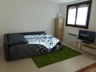 a bedroom with a bed and a flat screen tv at Gîte Montvauthier in Les Houches