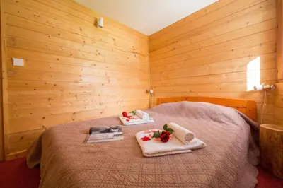 a bedroom with a bed with two towels on it at Résidence Grand Roc - Bruyères 207 - Happy Rentals in Chamonix-Mont-Blanc