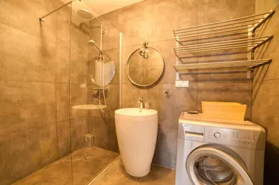 a bathroom with a washing machine and a sink at Residence du Brevent in Chamonix-Mont-Blanc