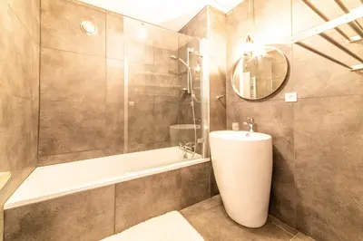 a bathroom with a shower and a toilet and a sink at Residence du Brevent in Chamonix-Mont-Blanc