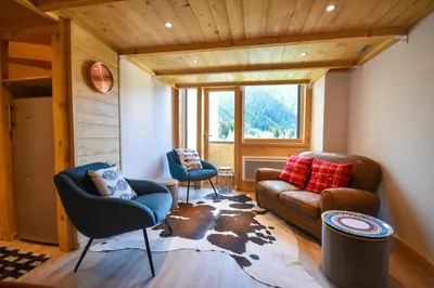 a living room with a couch and two chairs at Résidence Grand Roc - Campanules 308 - Happy Rentals in Chamonix-Mont-Blanc