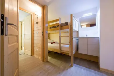 a small room with a bunk bed and a kitchen at Résidence Grand Roc - Campanules 308 - Happy Rentals in Chamonix-Mont-Blanc