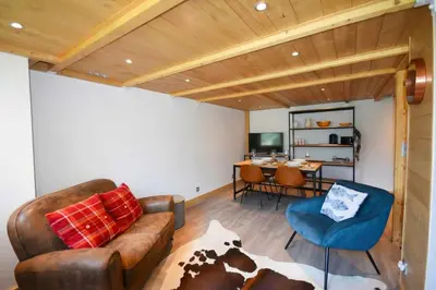 a dining room with a table with chairs and a bowl of fruit at Résidence Grand Roc - Campanules 308 - Happy Rentals in Chamonix-Mont-Blanc