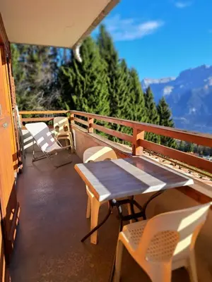 a table and chairs on a balcony with a view at Le Refuge in Cordon