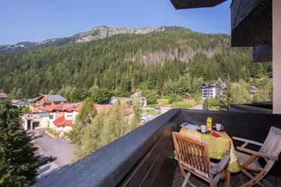 a living room with a white table and a couch at Résidence Grand Roc - Campanules 303 - Happy Rentals in Chamonix-Mont-Blanc