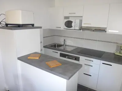a white kitchen with a sink and a microwave at Chalet Gabriel in Saint-Gervais-les-Bains