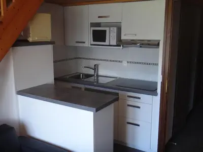a small kitchen with a sink and a microwave at Chalet Gabriel in Saint-Gervais-les-Bains