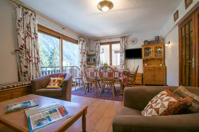 a living room with a couch and a table at Résidence Edelweiss 4 - Happy Rentals in Chamonix-Mont-Blanc
