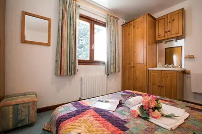 a bedroom with a bed with flowers on it at Résidence Edelweiss 4 - Happy Rentals in Chamonix-Mont-Blanc