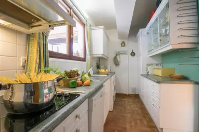 a kitchen with white cabinets and a counter top at Résidence Edelweiss 4 - Happy Rentals in Chamonix-Mont-Blanc