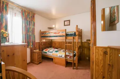 a bedroom with two bunk beds and a window at Résidence Edelweiss 4 - Happy Rentals in Chamonix-Mont-Blanc