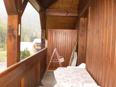 a wooden porch with a bench on a balcony at Location Montagne in Les Contamines-Montjoie