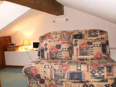 a bedroom with a large bed with a patterned bedspread at Location Montagne in Les Contamines-Montjoie