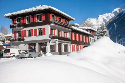 a building with a pile of snow in front of it at La Chaumière Mountain Lodge in Chamonix-Mont-Blanc