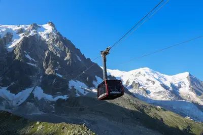 a ski lift in front of a snow covered mountain at La Chaumière Mountain Lodge in Chamonix-Mont-Blanc