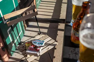 a sign sitting on a bench next to a building at La Chaumière Mountain Lodge in Chamonix-Mont-Blanc